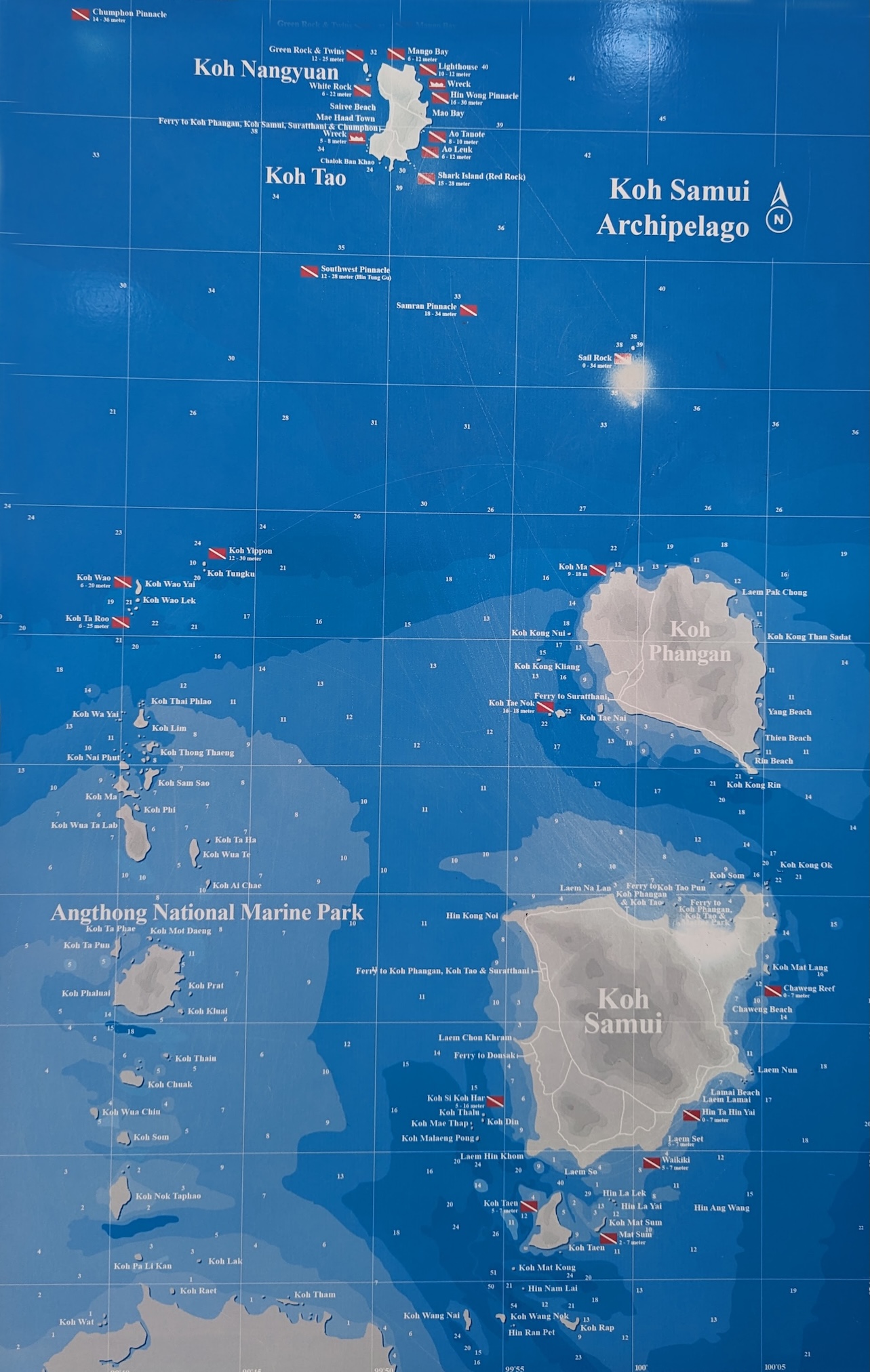 Map of Koh Samui Archipelago, showcasing spectacular Koh Samui diving spots and including islands like Koh Phangan, Koh Tao, and Angthong National Marine Park. Various dive sites are marked with red flags against the blue ocean backdrop. North is indicated with an arrow.